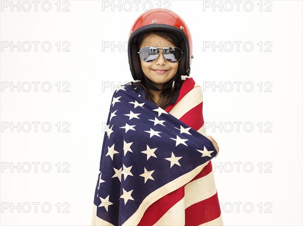 Mixed race girl wrapped in American flag