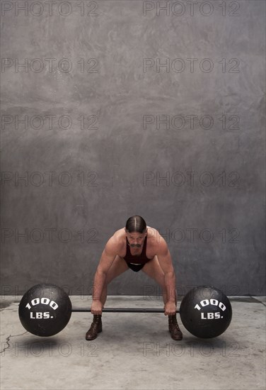 Caucasian weight lifter straining