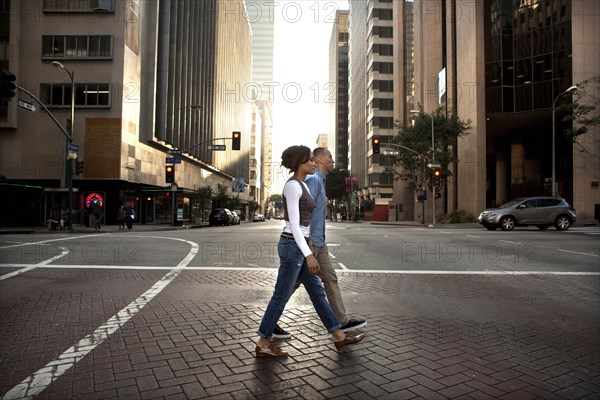 Couple crossing city street