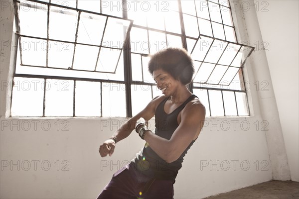 African American man dancing in loft