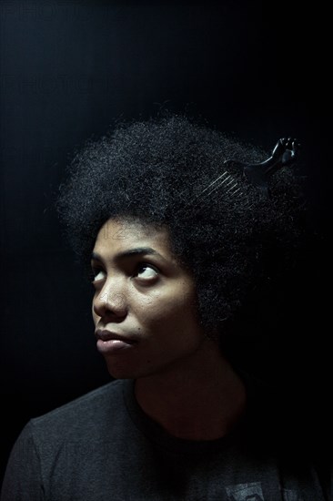 African American man wearing comb in afro hairstyle