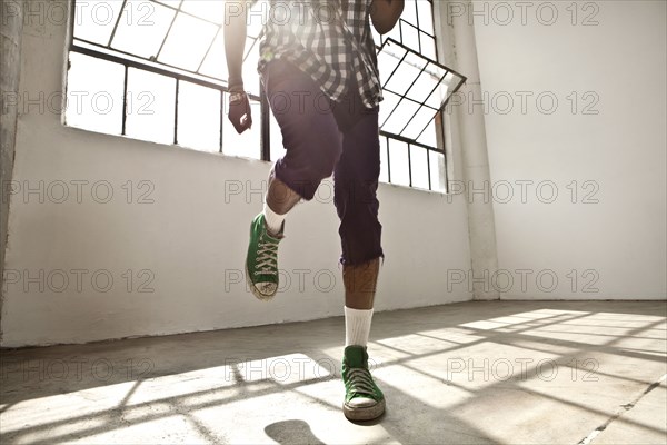 African American man dancing in loft