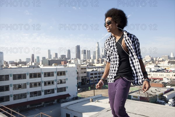 African American man standing on urban rooftop
