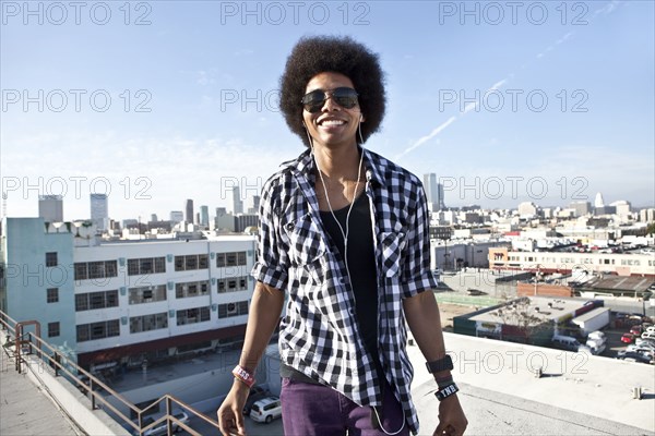 African American man standing on urban rooftop