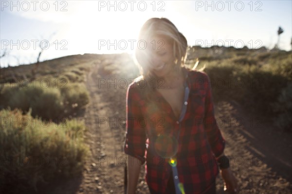 Caucasian woman walking on dirt road