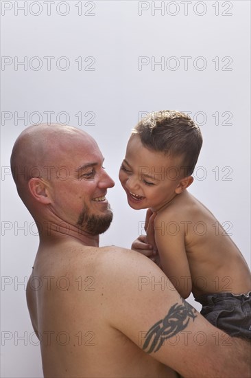 Caucasian father holding son