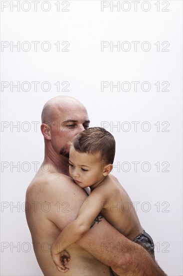 Caucasian father holding son