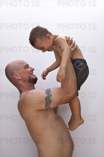 Caucasian father holding son