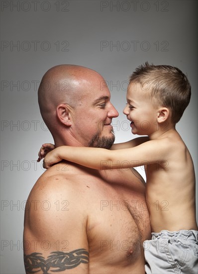 Caucasian father holding son