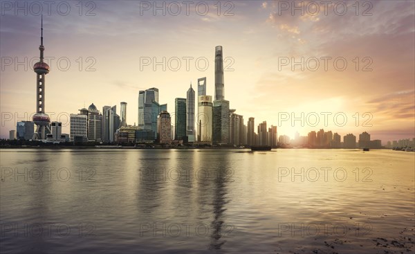 Shanghai city skyline reflecting in waterfront