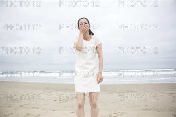 Woman laughing on beach