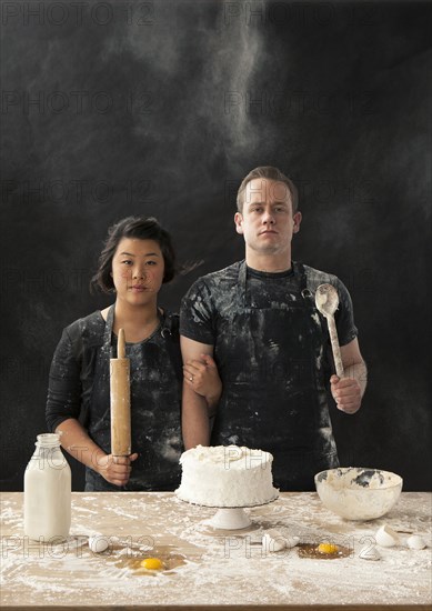 Messy couple baking cake