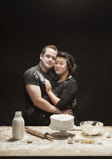 Messy couple baking cake
