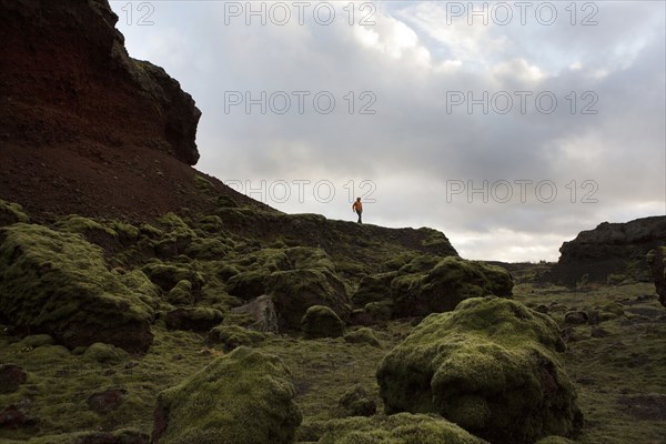 Caucasian hiker walking on rock formation