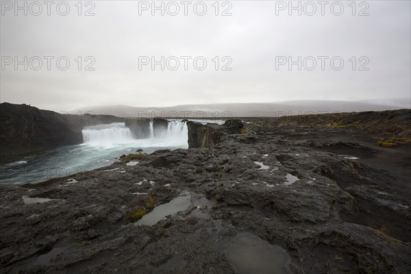 Rock formation cliffs near remote waterfall