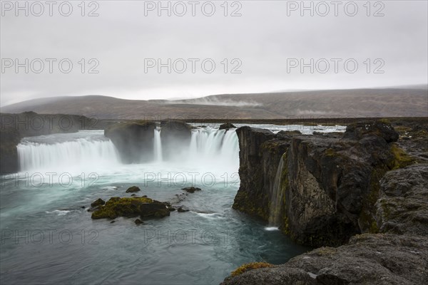 Rock formation cliffs near remote waterfall