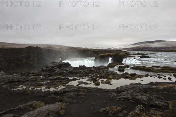 Rock formation cliffs near remote waterfall