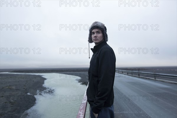 Caucasian man standing on remote road