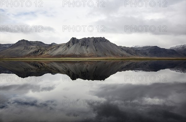 Mountains reflecting in still lake