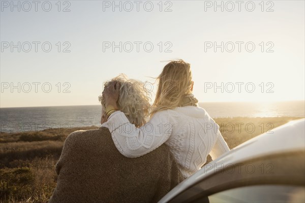 Older Caucasian couple looking at ocean view