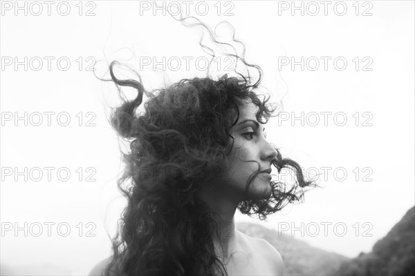 Wind blowing hair of Mixed Race woman