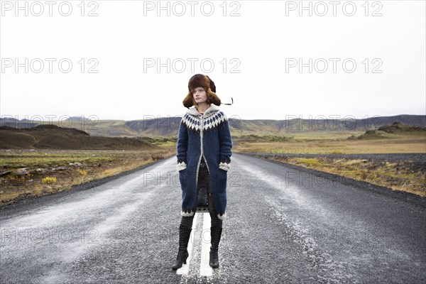 Caucasian woman standing in middle of road