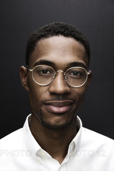 Portrait of smiling Black man wearing eyeglasses