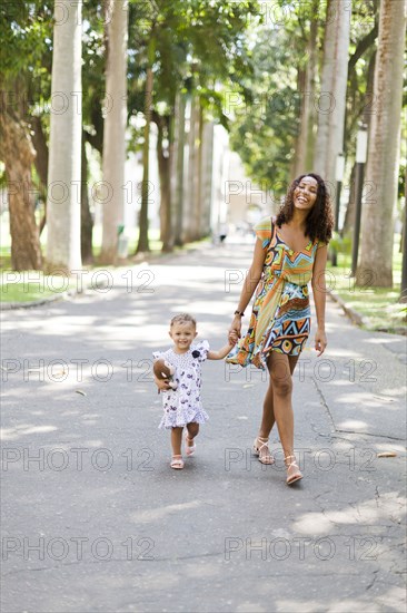 Mother and daughter walking in park