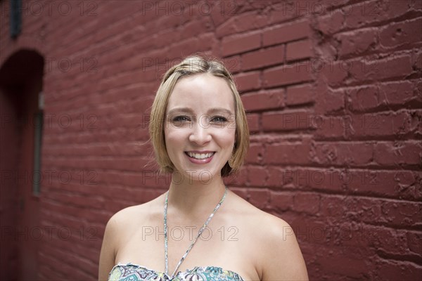 Caucasian woman smiling on city street