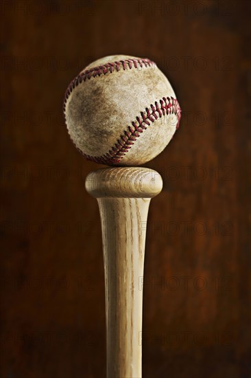 Baseball balancing on baseball bat