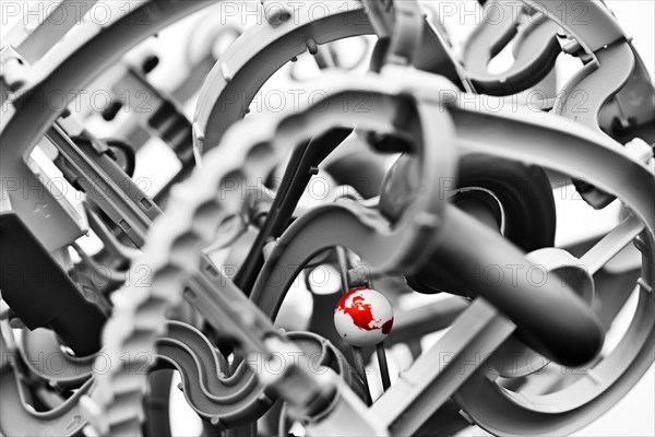 Close up globe among gears in machine