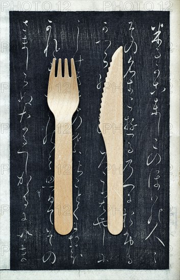 Wooden fork and knife on chalkboard