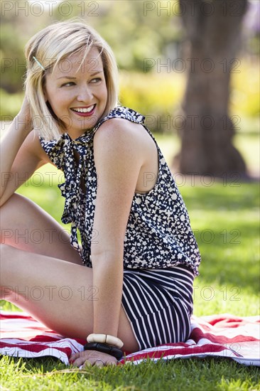 Caucasian woman smiling in grass