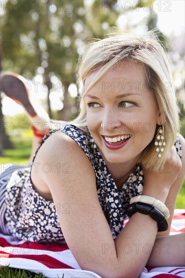 Caucasian woman laying in grass