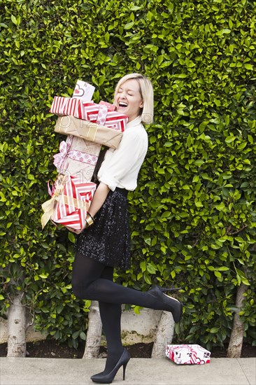 Caucasian woman carrying Christmas gifts