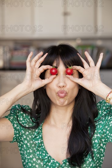 Woman playing with tomatoes