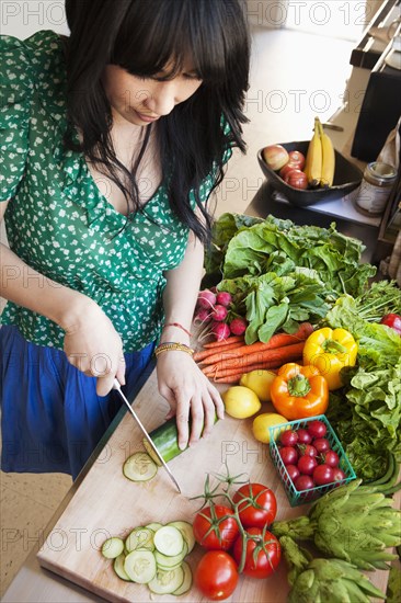 Woman chopping vegetables in kitchen