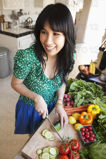 Woman chopping vegetables in kitchen