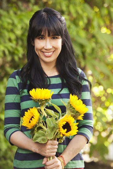 Woman holding bouquet of sunflowers