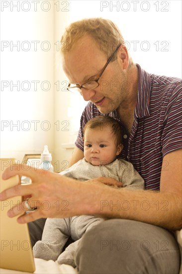 Father reading to baby boy