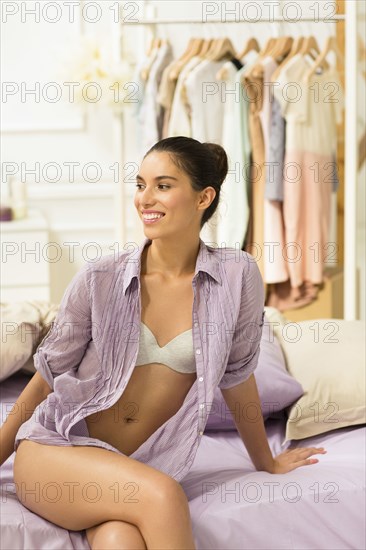 Caucasian woman sitting on bed