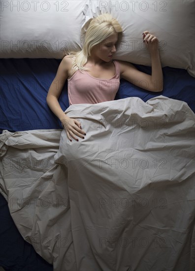 Caucasian woman sleeping in bed