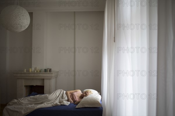 Caucasian woman sleeping in bed