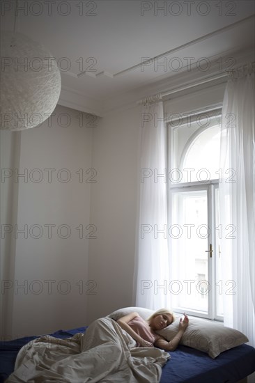 Caucasian woman sleeping in bed