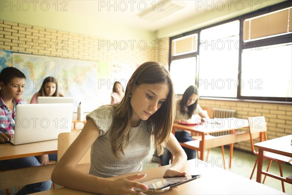 Student using digital tablet in classroom