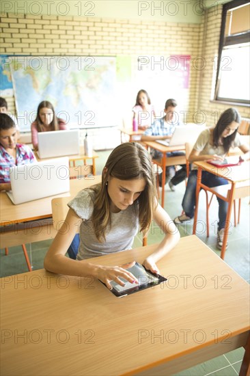 Student using digital tablet in classroom