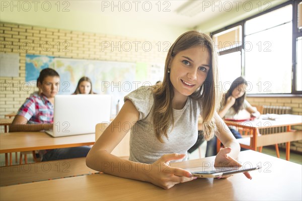 Student using digital tablet in classroom