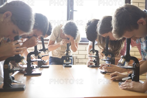 Students using microscopes in science class