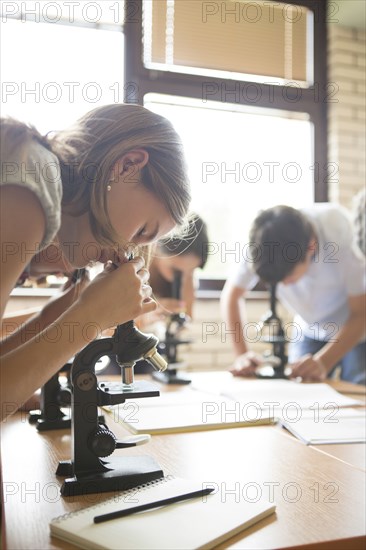 Students using microscopes in science class