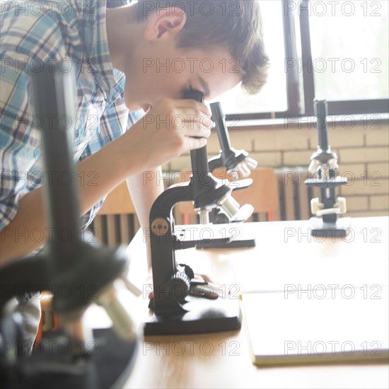 Student using microscopes in science class